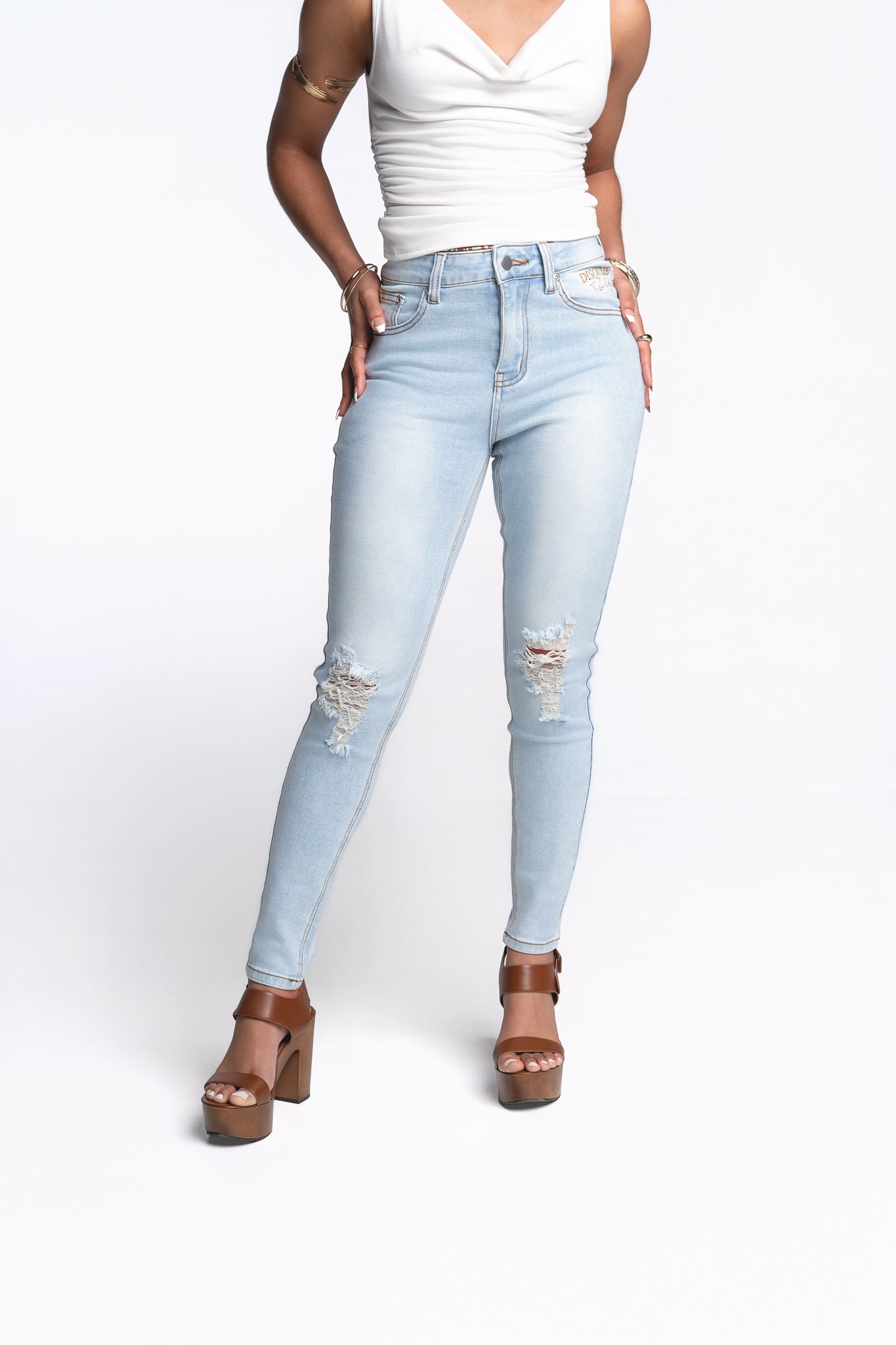 Women's light wash distressed LUXE denim jeans with tailored fit