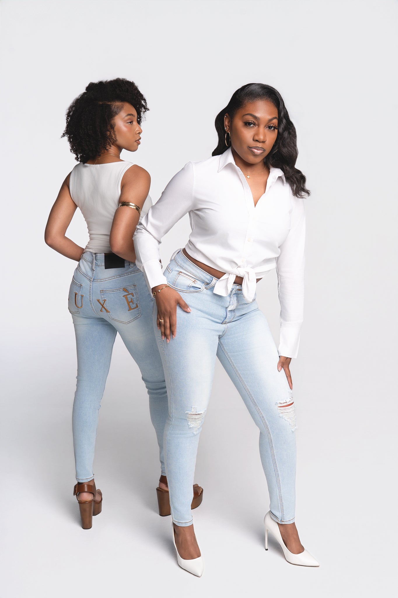 Women's light wash distressed LUXE denim jeans with tailored fit